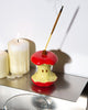 ceramic incense holder in the shape of a red apple core