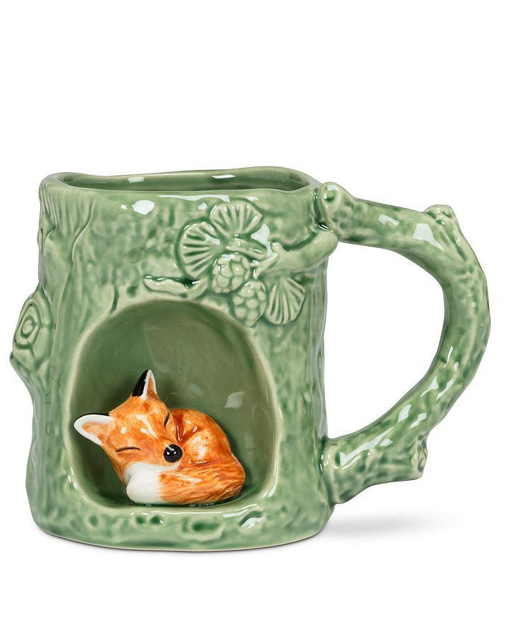 green ceramic mug with tree detailing and fox icon