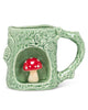 green ceramic mug with tree detailing and mushroom icon