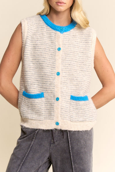 knit sweater vest in cream and light grey with bright blue detailing on buttons, neckline, and pockets