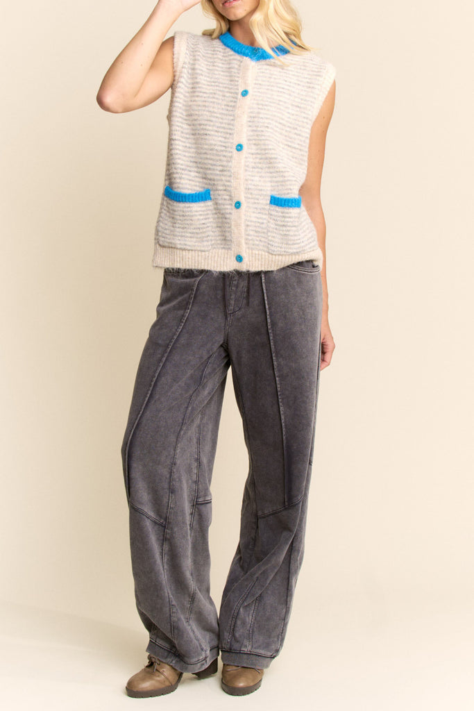 knit sweater vest in cream and light grey with bright blue detailing on buttons, neckline, and pockets