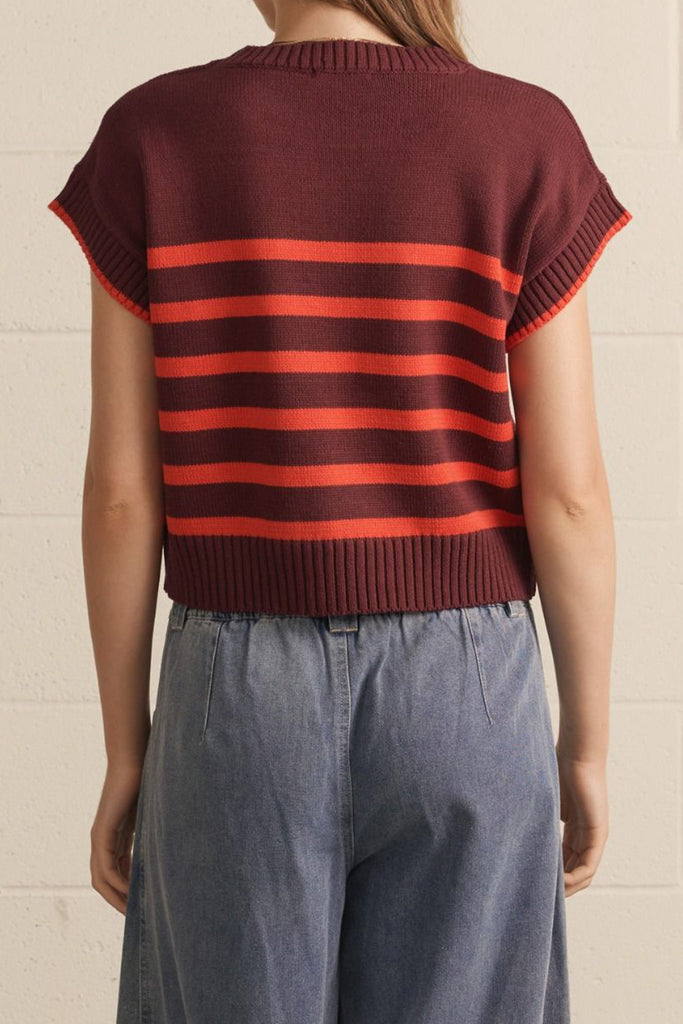 knit top in a deep wine color with bold orange stripes