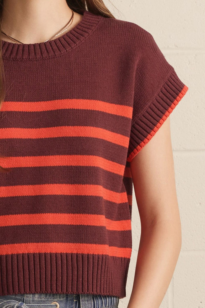 knit top in a deep wine color with bold orange stripes