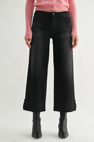 washed black wide leg jeans with a cuffed bottom hem.