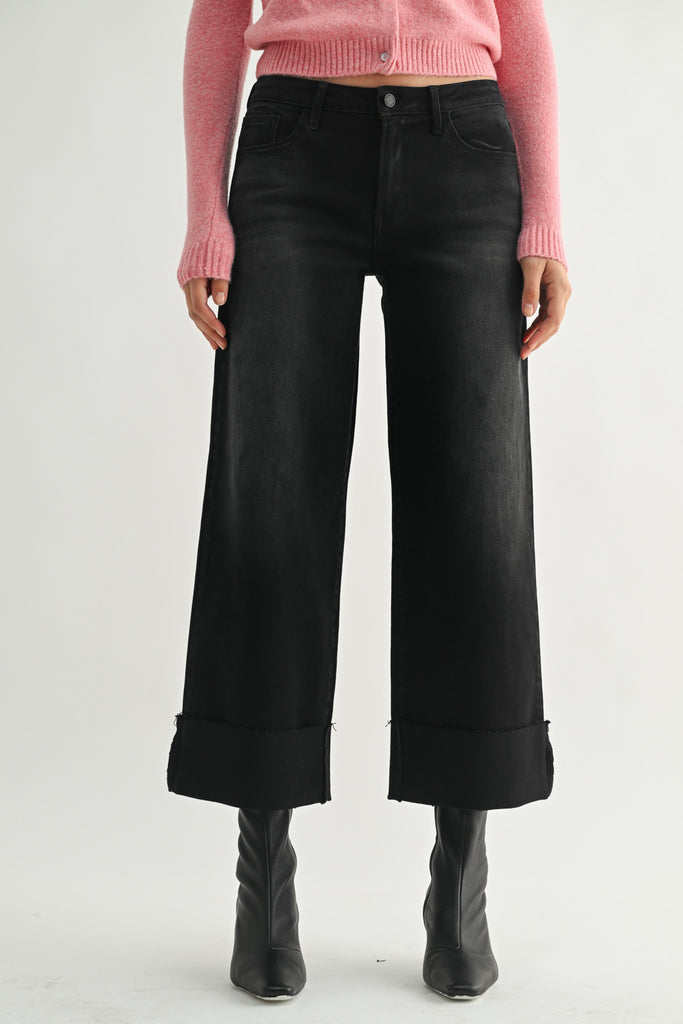 washed black wide leg jeans with a cuffed bottom hem.