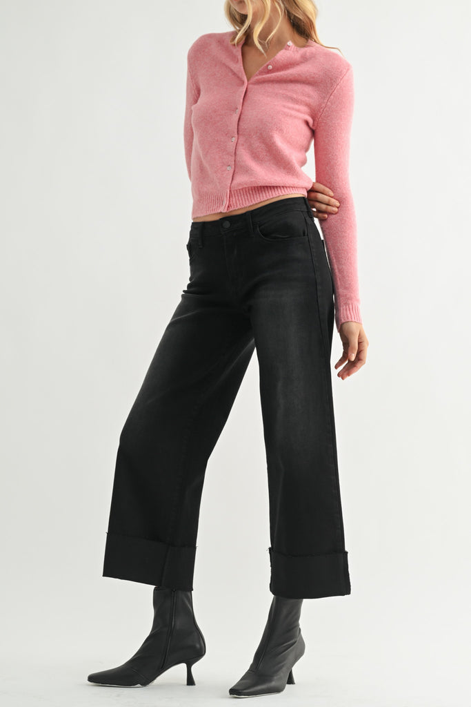 washed black wide leg jeans with a cuffed bottom hem.