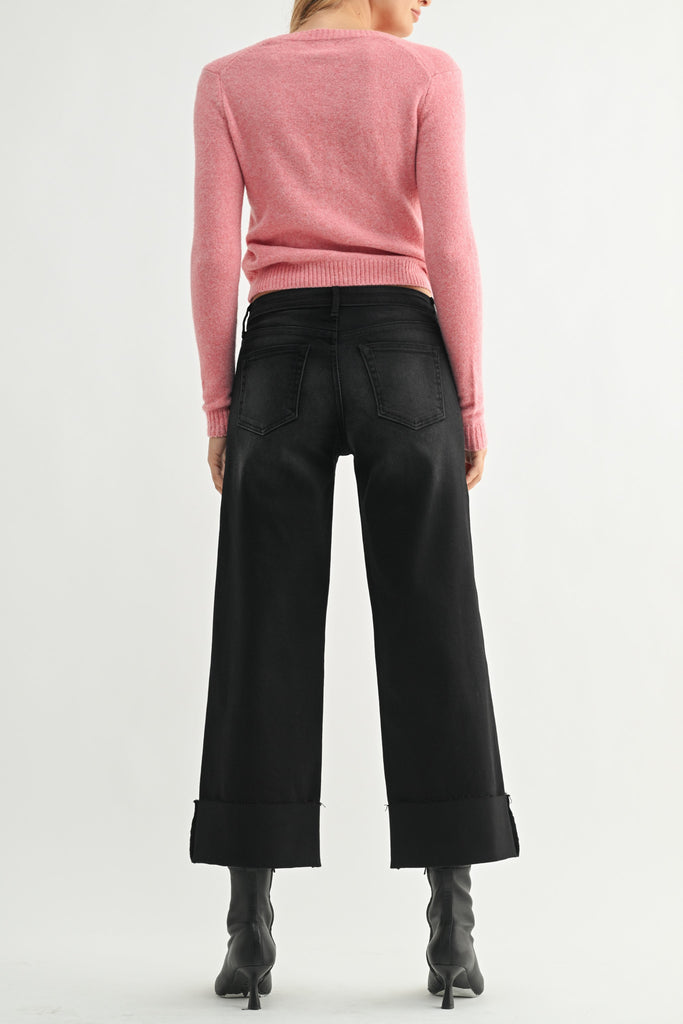 washed black wide leg jeans with a cuffed bottom hem.