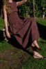 striking midi dress in a dark plaid pattern with smocked details
