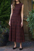 striking midi dress in a dark plaid pattern with smocked details