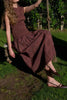 striking midi dress in a dark plaid pattern with smocked details